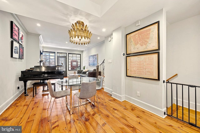 dining area with a chandelier, light wood-style flooring, recessed lighting, baseboards, and crown molding