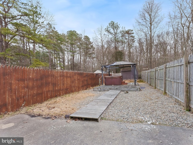 view of yard featuring a fenced backyard and a hot tub