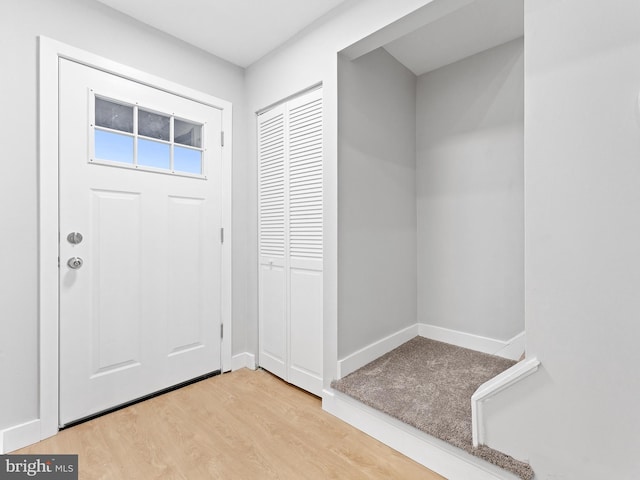 foyer featuring light wood-type flooring and baseboards