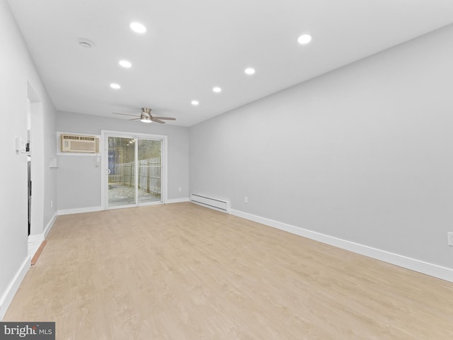 empty room featuring a baseboard heating unit, recessed lighting, baseboards, and light wood-style floors