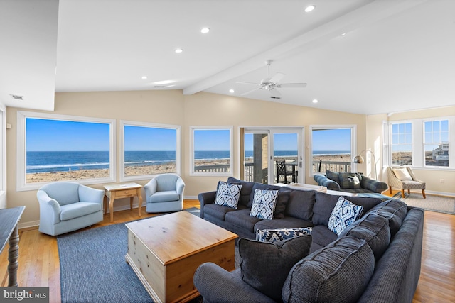 living area featuring recessed lighting, lofted ceiling with beams, and wood finished floors