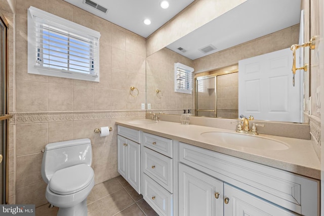 full bathroom with visible vents, tile walls, and a sink