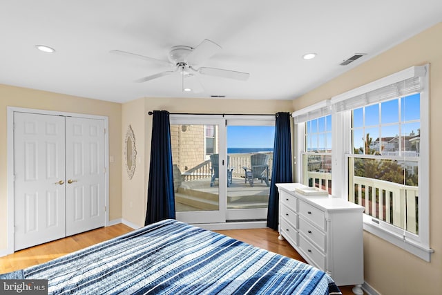 bedroom featuring visible vents, wood finished floors, baseboards, and access to exterior