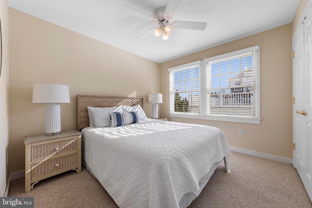 bedroom with baseboards, carpet floors, and a ceiling fan