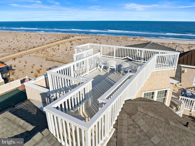 drone / aerial view with a beach view and a water view