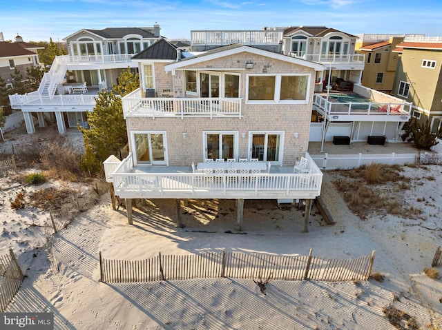 back of property with a balcony and a deck