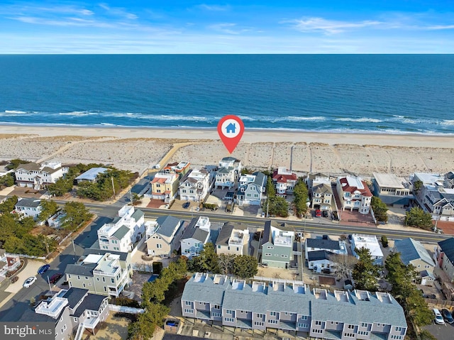 aerial view featuring a residential view, a water view, and a beach view