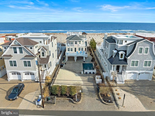 birds eye view of property with a residential view, a water view, and a view of the beach