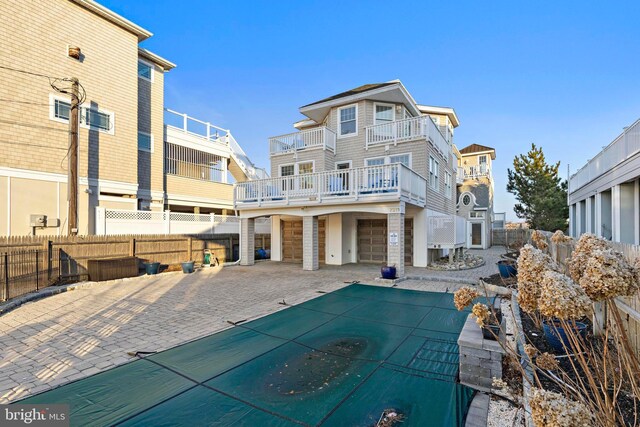 back of property featuring a patio, a fenced backyard, a garage, and driveway