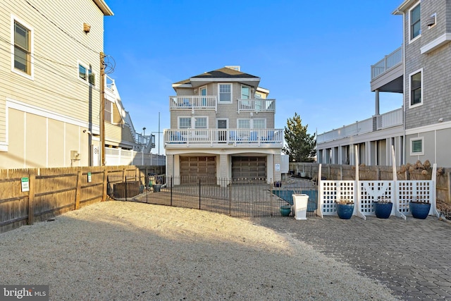 view of front of property with a garage and fence