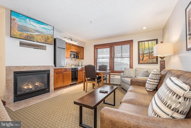 living room with a tile fireplace and recessed lighting