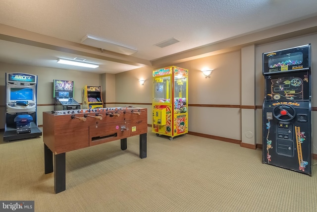 game room featuring a textured ceiling, carpet floors, visible vents, and baseboards