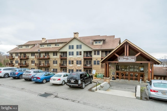 view of building exterior with uncovered parking