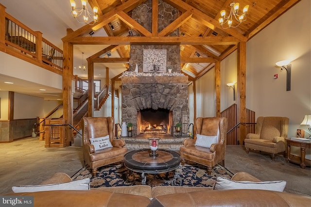 living area with a stone fireplace, beamed ceiling, wooden ceiling, and an inviting chandelier