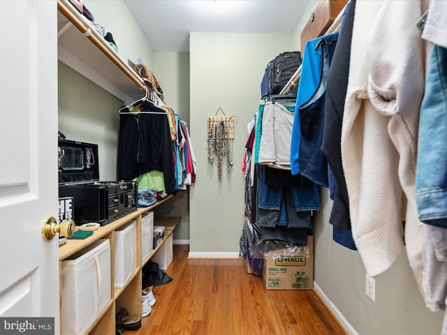 walk in closet featuring wood finished floors