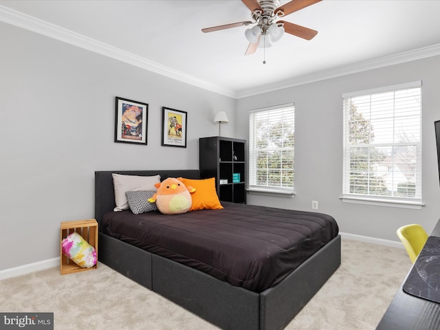bedroom featuring carpet flooring, crown molding, baseboards, and ceiling fan
