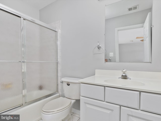 bathroom with toilet, vanity, bath / shower combo with glass door, and visible vents