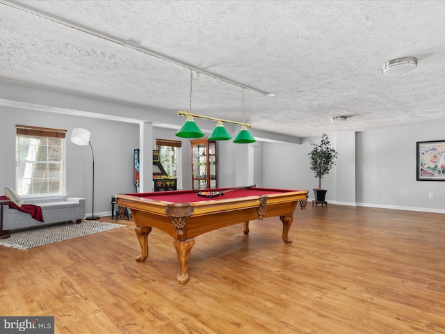 playroom with baseboards, billiards, wood finished floors, and a textured ceiling