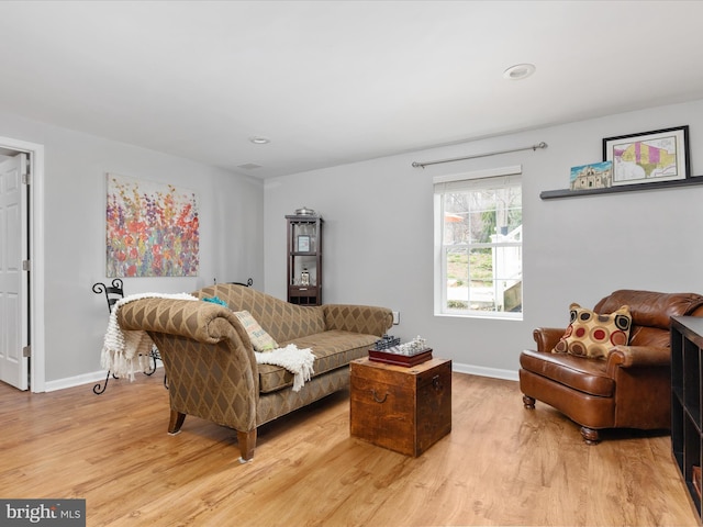 living room featuring baseboards and light wood-style flooring