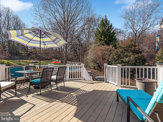 wooden deck featuring outdoor dining space