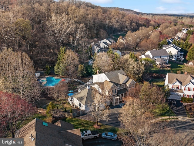 drone / aerial view with a residential view and a forest view