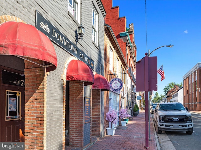 exterior space with curbs, traffic signs, street lights, and sidewalks