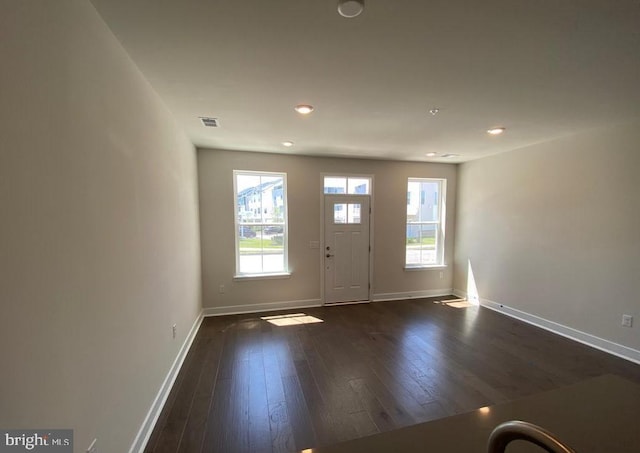 foyer featuring dark wood-type flooring, recessed lighting, visible vents, and baseboards