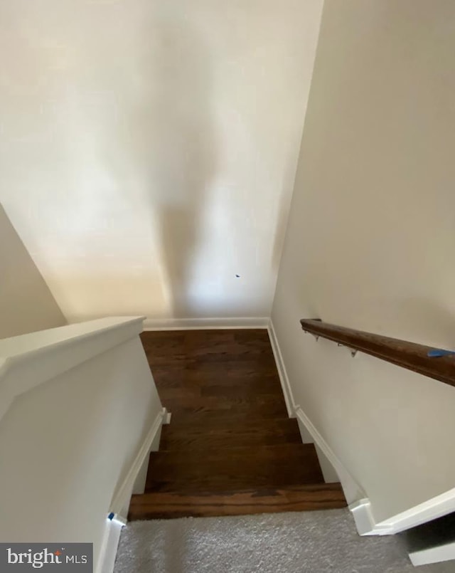 staircase featuring baseboards