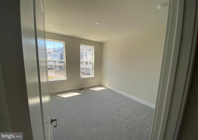 empty room with carpet flooring and baseboards