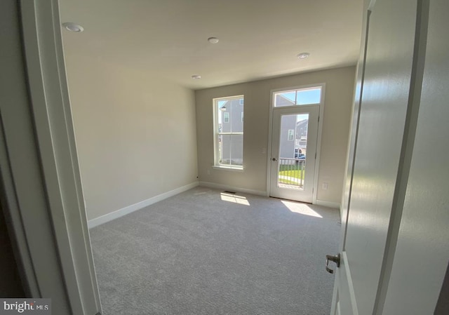 spare room featuring baseboards and carpet flooring