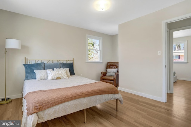 bedroom featuring baseboards and wood finished floors