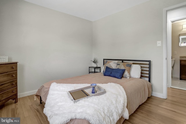 bedroom featuring baseboards and wood finished floors