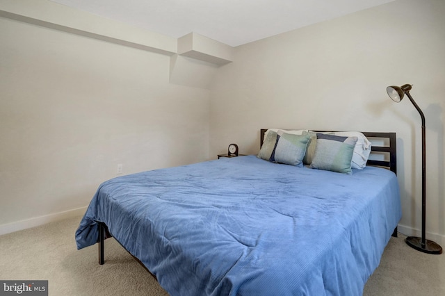 bedroom featuring baseboards and carpet