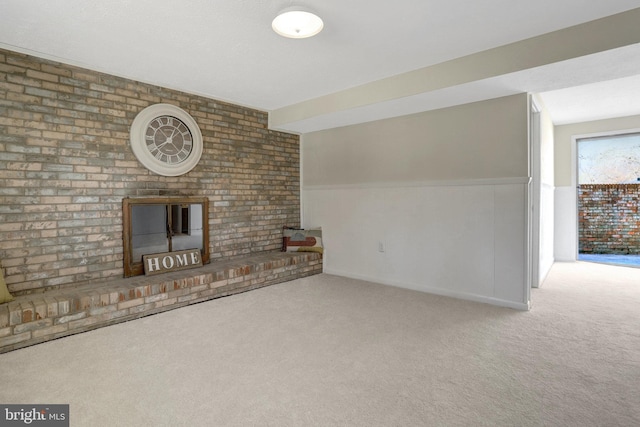 unfurnished living room with carpet flooring, wainscoting, and a fireplace