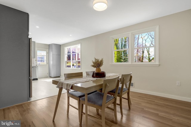 dining room featuring recessed lighting, baseboards, and light wood-style floors