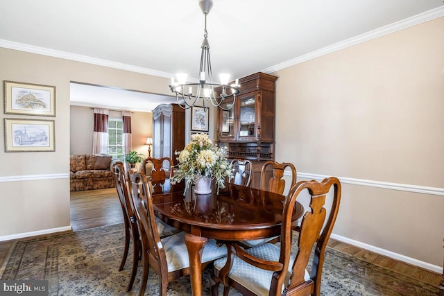 dining room with baseboards, a notable chandelier, dark wood-style floors, and crown molding