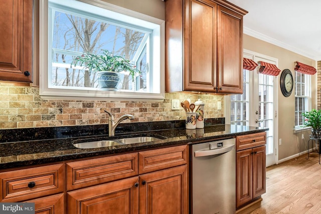 kitchen with tasteful backsplash, crown molding, brown cabinets, stainless steel dishwasher, and a sink