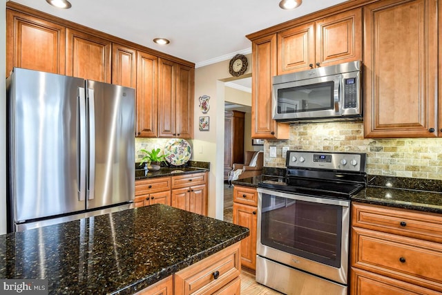 kitchen with crown molding, brown cabinetry, tasteful backsplash, and appliances with stainless steel finishes