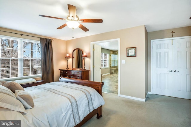 bedroom featuring a closet, light carpet, baseboards, and ceiling fan