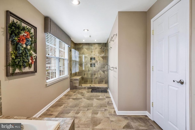 bathroom with recessed lighting, a shower stall, and baseboards