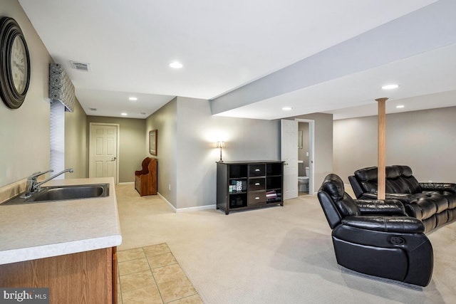 living area with recessed lighting, light colored carpet, visible vents, and baseboards