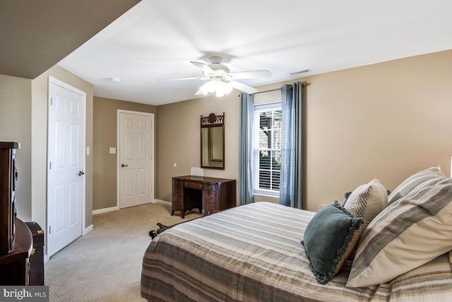 bedroom featuring visible vents, baseboards, a ceiling fan, and carpet flooring