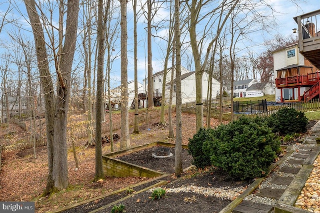 view of yard with a residential view, a vegetable garden, stairs, and fence