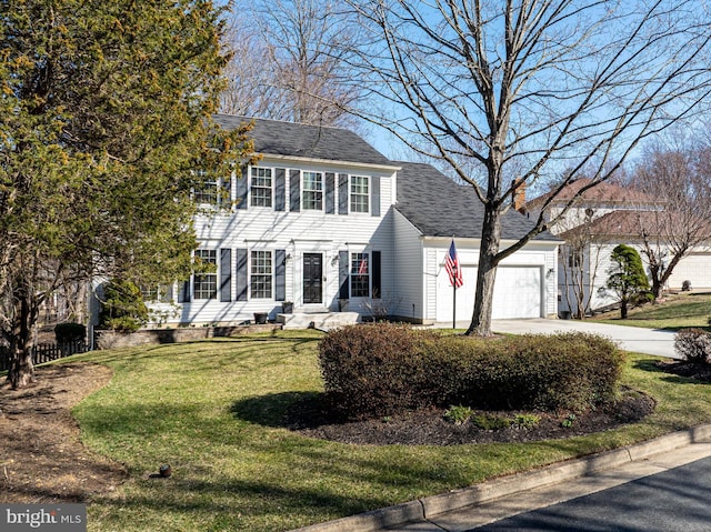 colonial home with a front yard, a shingled roof, a chimney, concrete driveway, and a garage