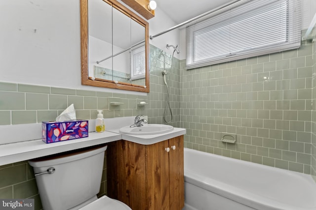 full bath with vanity, tile walls, toilet, and shower / tub combination