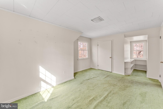 carpeted empty room with baseboards