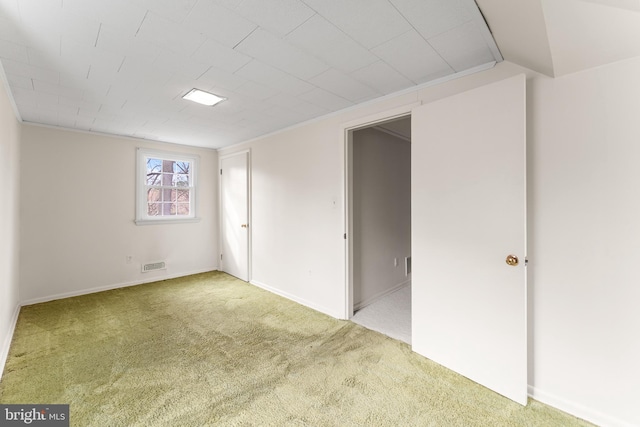 empty room featuring visible vents and carpet flooring