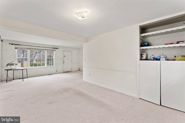 interior space featuring carpet and baseboards