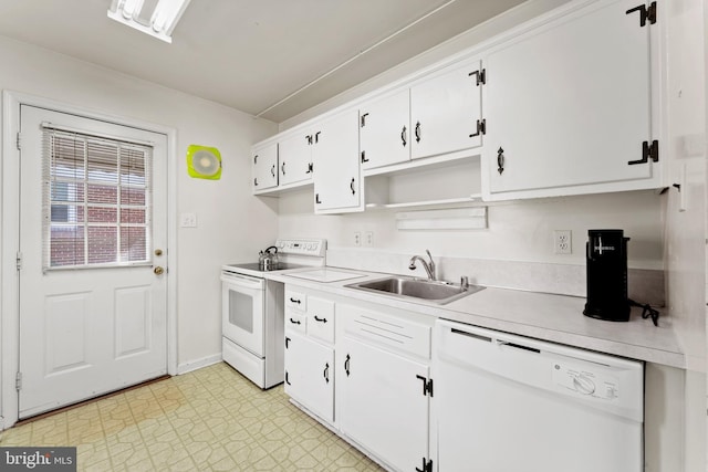 kitchen with light floors, light countertops, white appliances, white cabinetry, and a sink