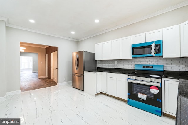 kitchen featuring white cabinets, dark countertops, decorative backsplash, and appliances with stainless steel finishes